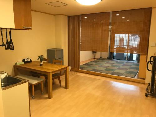 a kitchen with a table and a dining room at HOSTEL PAQ tokushima / Vacation STAY 35580 in Tokushima