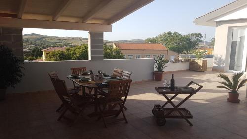 a patio with a table and chairs on a patio at Relais La Terrazza in Palmadula