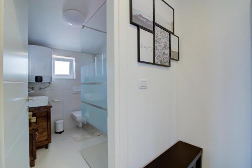 a bathroom with a sink and a toilet in a room at VisumApartments in Senj