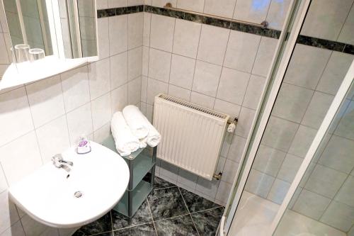 a bathroom with a sink and a shower at Haus Alpengluehn in Iselsberg