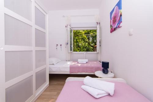 Posteľ alebo postele v izbe v ubytovaní Apartman Sun Solin