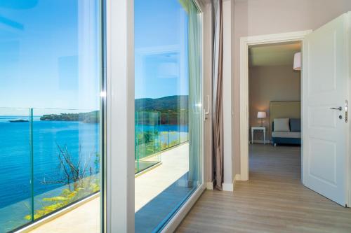 a room with a view of the water at Hotel Plaza in Porto Azzurro