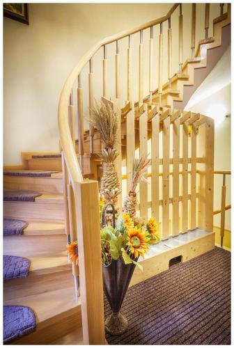 a staircase with a vase with flowers in it at Tatrzańska Kotwica in Witów