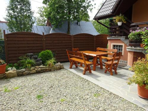 a patio with a wooden table and chairs at Tatrzańska Kotwica in Witów