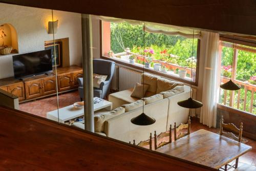 a living room with a couch and a large window at Can MiA in Bas