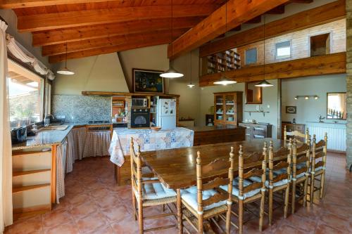 a large kitchen with a wooden table and chairs at Can MiA in Bas