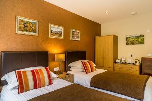 a hotel room with two beds in a room at Hermiston Guest House in Keswick