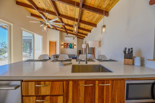 a kitchen with a sink and a counter top at Villa Topaz Above West Bay with 360 Degree Views! in West Bay