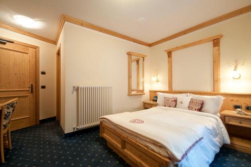 a hotel room with a bed and a window at Hotel Gianna in Madonna di Campiglio