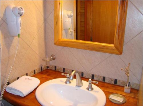 a bathroom counter with a sink and a mirror at Cabañas En el Corazón del Bosque in San Carlos de Bariloche