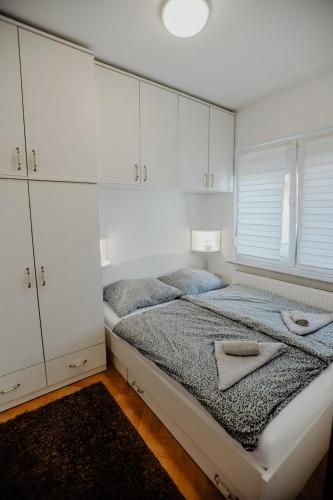 a bedroom with a bed with two towels on it at Apartman M5 in Đakovo