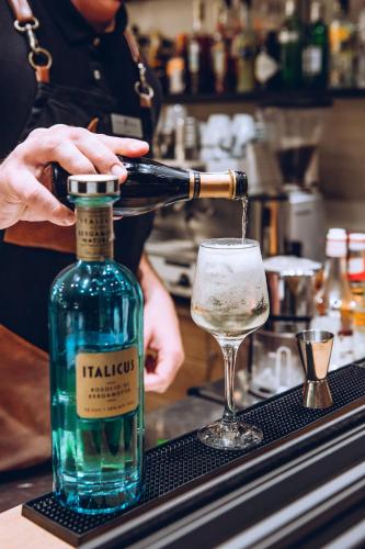 a person pouring a bottle of wine into a glass at Libyan Princess in Palaiochóra
