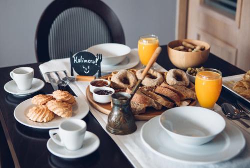 a table with a breakfast of pastries and orange juice at Libyan Princess in Palaiochóra