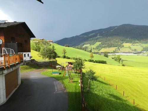 a balcony of a house with a view of a field at Bauernhof Unterbichl in Flachau