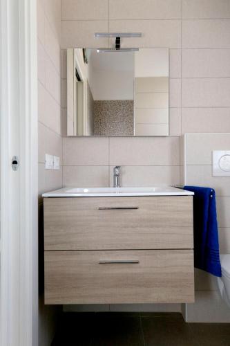 a bathroom with a sink and a mirror at Appartamenti Lino in Caorle