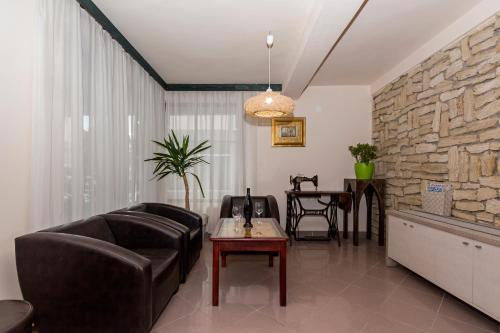 a living room with a couch and a table at Bitrak Guest House in Ohrid