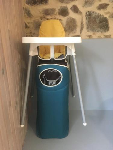 a table and a trash can under a table and a chair at Moulin de la Fayolle in Blot-lʼÉglise