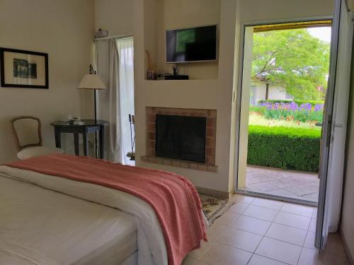 a bedroom with a fireplace and a sliding glass door at Hotel Boutique Posada Piedras Blancas in Santa Rosa