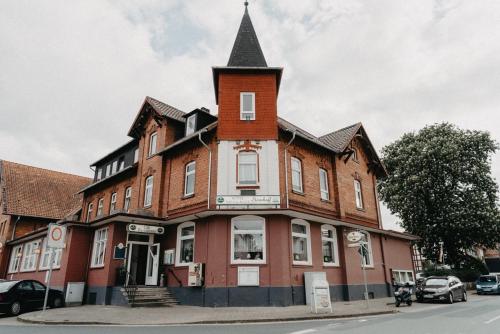 a large building with a tower on top of it at Hotel Steinhoff in Freden