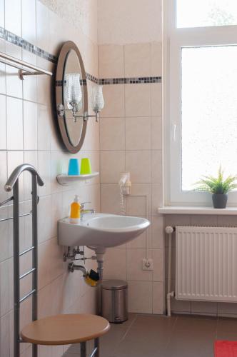 a bathroom with a sink and a mirror at Landhaus Nauenburg in Heere