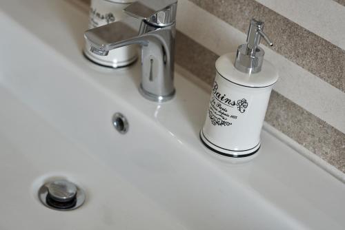 a bathroom sink with a soap dispenser on it at SUNNY SIDE in Trogir