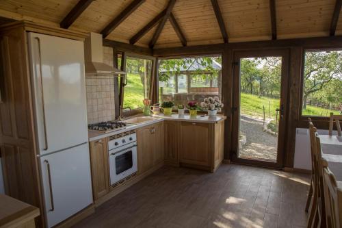 a kitchen with a refrigerator and a stove at Trout Cottage in Bran