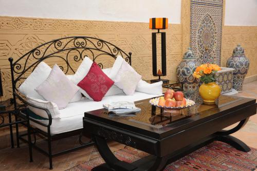 a living room with a white couch and a coffee table at Riad Shaden in Marrakech