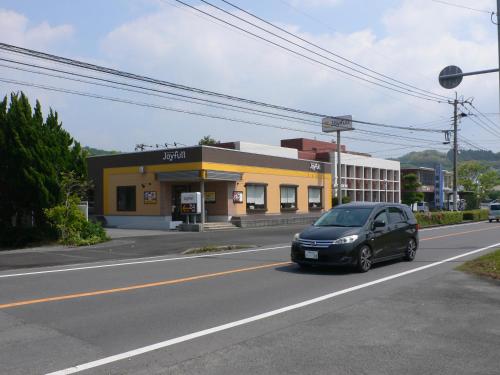 a black car parked in front of a building at Guesthouse RETURN in Kitsuki
