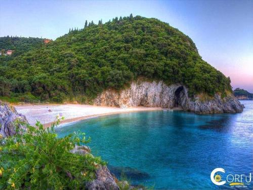 an island in the ocean with a sandy beach at ELIA in Doukádes