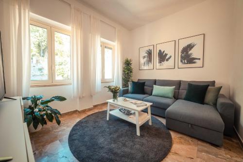 a living room with a couch and a table at B&B Teatro Greco 39 in Taormina