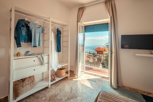 a room with a dresser and a window with a view at B&B Teatro Greco 39 in Taormina