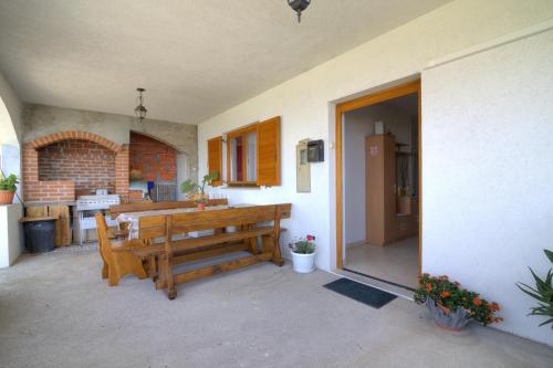 a patio with a wooden bench and a kitchen at Josipa & Jelena Apartment in Senj