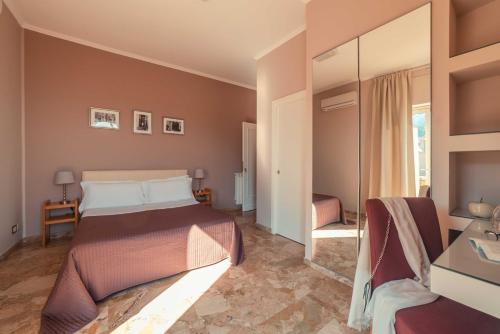 a bedroom with a bed and a mirror at B&B Teatro Greco 39 in Taormina
