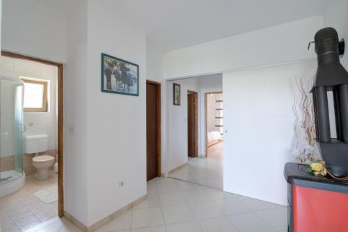 a kitchen with white walls and a toilet in a room at Josipa & Jelena Apartment in Senj
