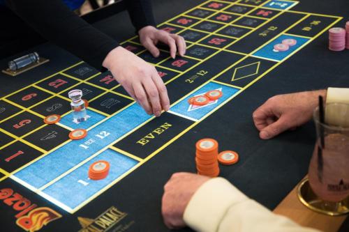 two people playing a game of poker on a table at Mineral Palace Hotel & Gaming in Deadwood