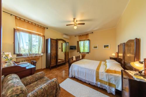 a bedroom with a bed and a couch at Agriturismo Isola Dei Calanchi - Guest House in Atri