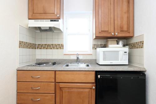 a kitchen with a sink and a microwave at Stardust Motel in Wildwood