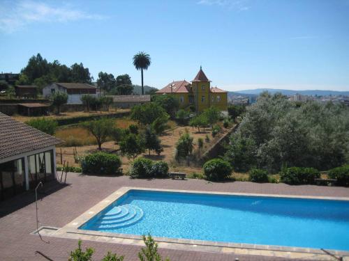 a large swimming pool in front of a house at Casa da Torre luxury villa in Braga in Braga