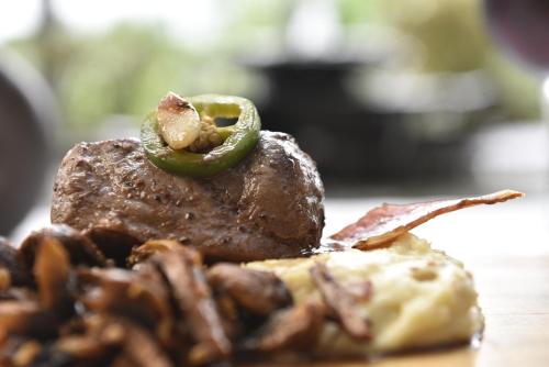 a plate of food with a piece of meat and aucleotide at Colombe Hotel Boutique in Xalapa