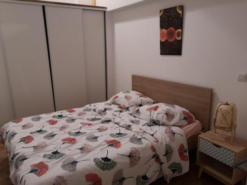 une chambre avec un lit avec une couette dessus dans l'établissement Maison 2 chambres, cosy, proche Métro, à Toulouse