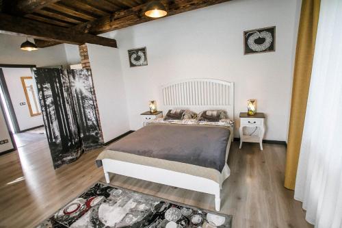 a bedroom with a bed and two night stands at Lindenhoff in Liepasmuiža