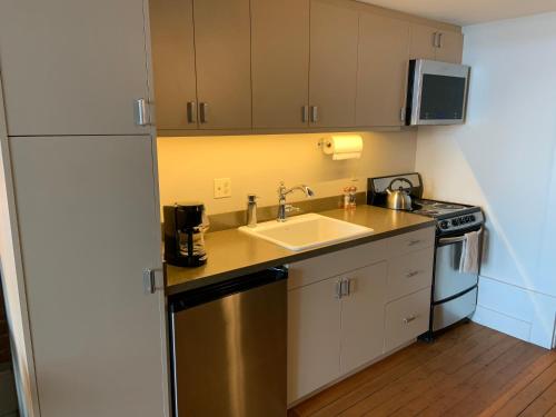 a small kitchen with a sink and a stove at The Palace Hotel in Port Townsend