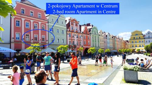 a group of people standing in a street with buildings at Apartament Przy Starówce - Bella in Bolesławiec