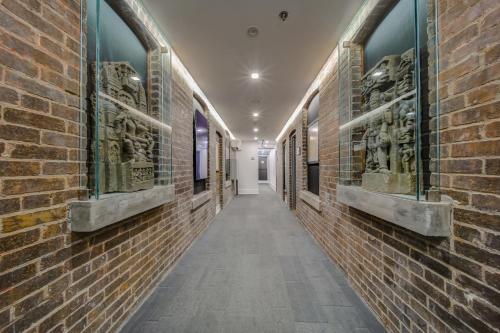a hallway of a brick building with statues on the walls at The Westlake in Toronto