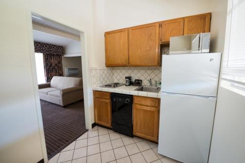 a kitchen with a white refrigerator and a couch at Los Gatos Lodge in Los Gatos