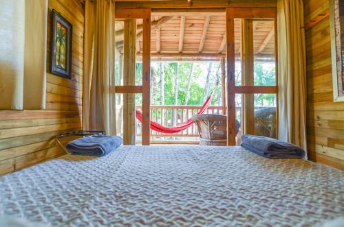 a bedroom with a large bed with pillows on it at Hotel Oasis & Surf Camp in Santa Catalina