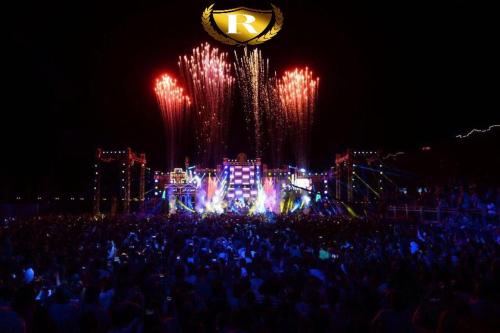 a crowd of people in front of a stage with fireworks at Rehana Plaza Hotel in Cairo