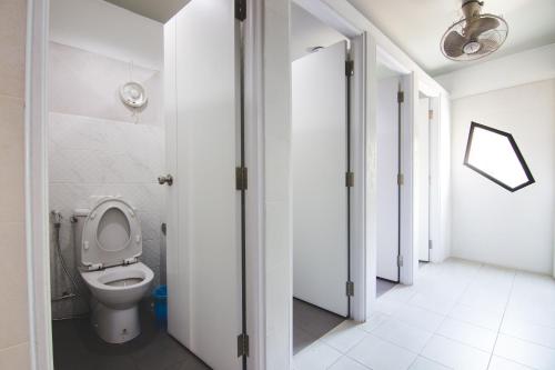a bathroom with a toilet in a room at The August Hostel in Chiang Mai