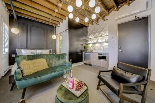 a living room with a green couch and a table at The Westlake in Toronto