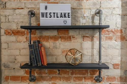 a shelf in front of a brick wall with a box at The Westlake in Toronto